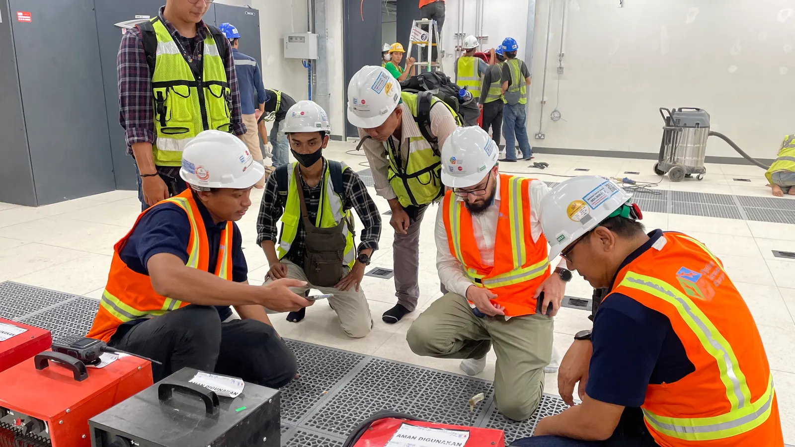 Engineers taking part in on-site training with a NEBB certified professional